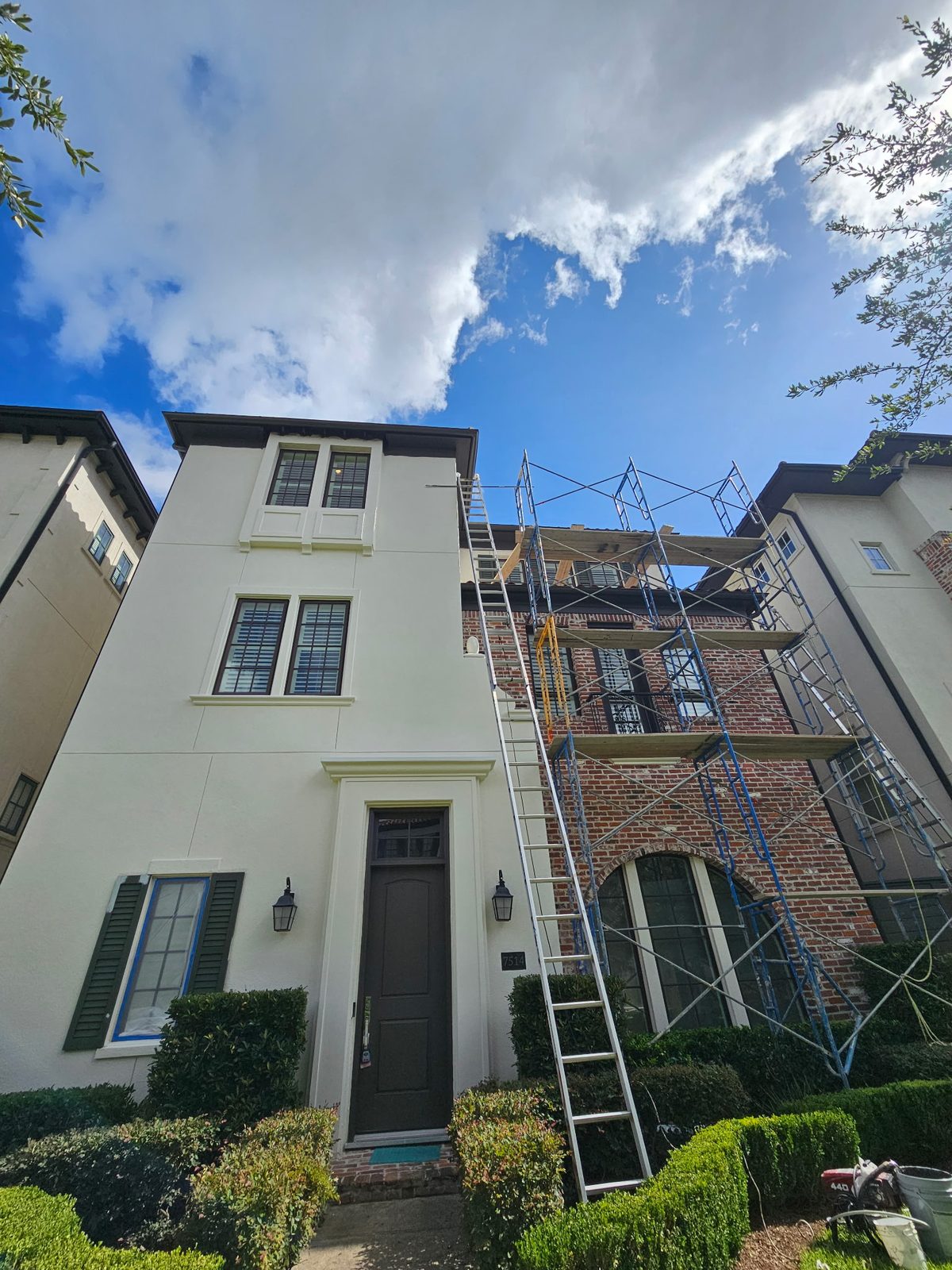 Exterior house painting project with freshly coated siding and trim