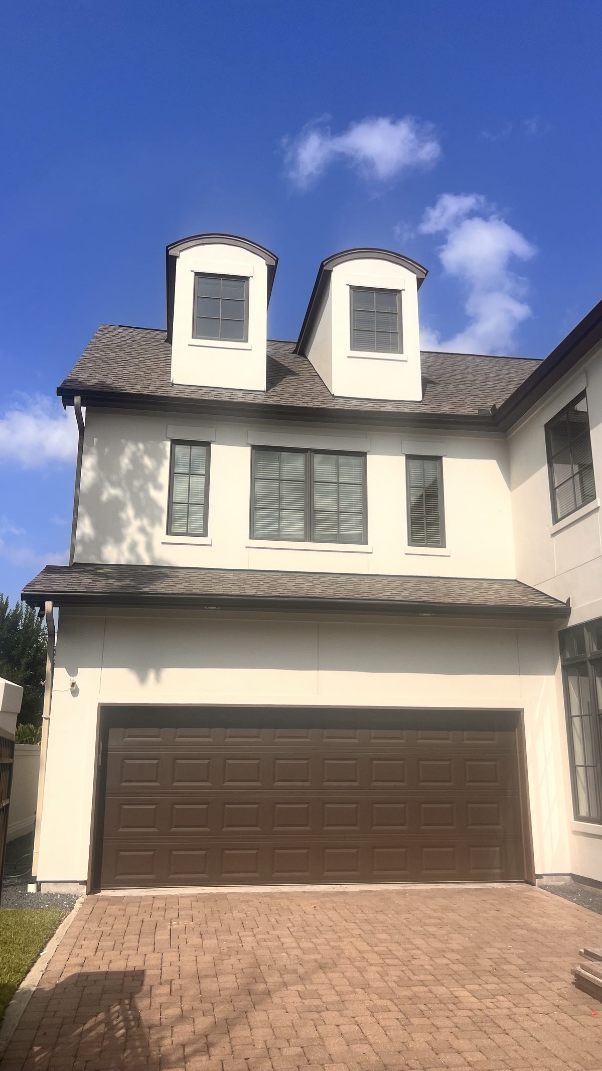Two-story stucco home with fresh trim work