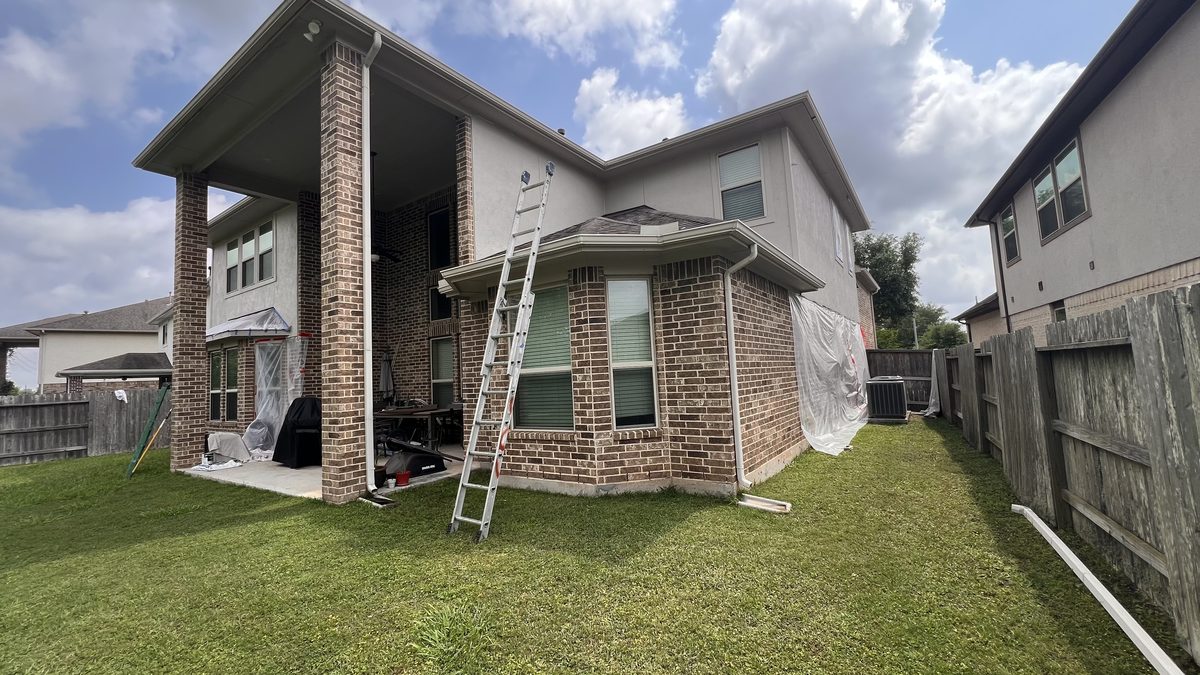 Masked and prepped siding before spraying
